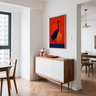 Cranes Silhouette Art Print showing a black crane with a red sun in the background above a sideboard with a cat ornament