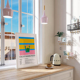 Drink wall art for kitchen with old fashioned cocktail illustration in bright pastel colours leaning on a kitchen counter with kettle