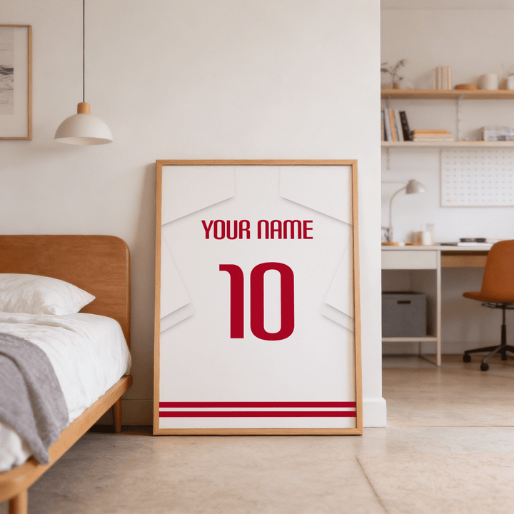 Football Shirt Poster in White with Red Number leaning on floor near bed in a bedroom scene