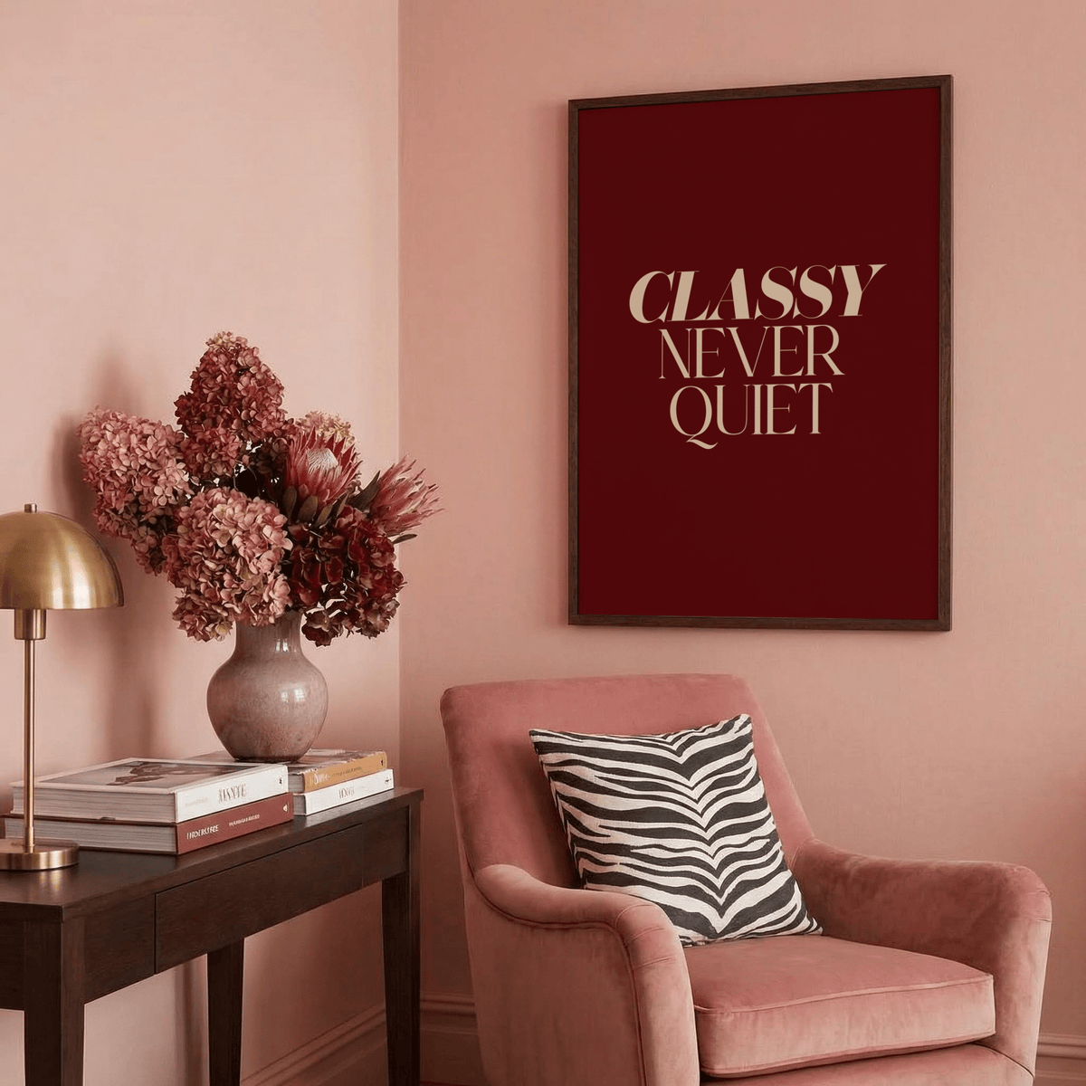 Classy wall art with beige text on dark red above chair with zebra cushion in pink room