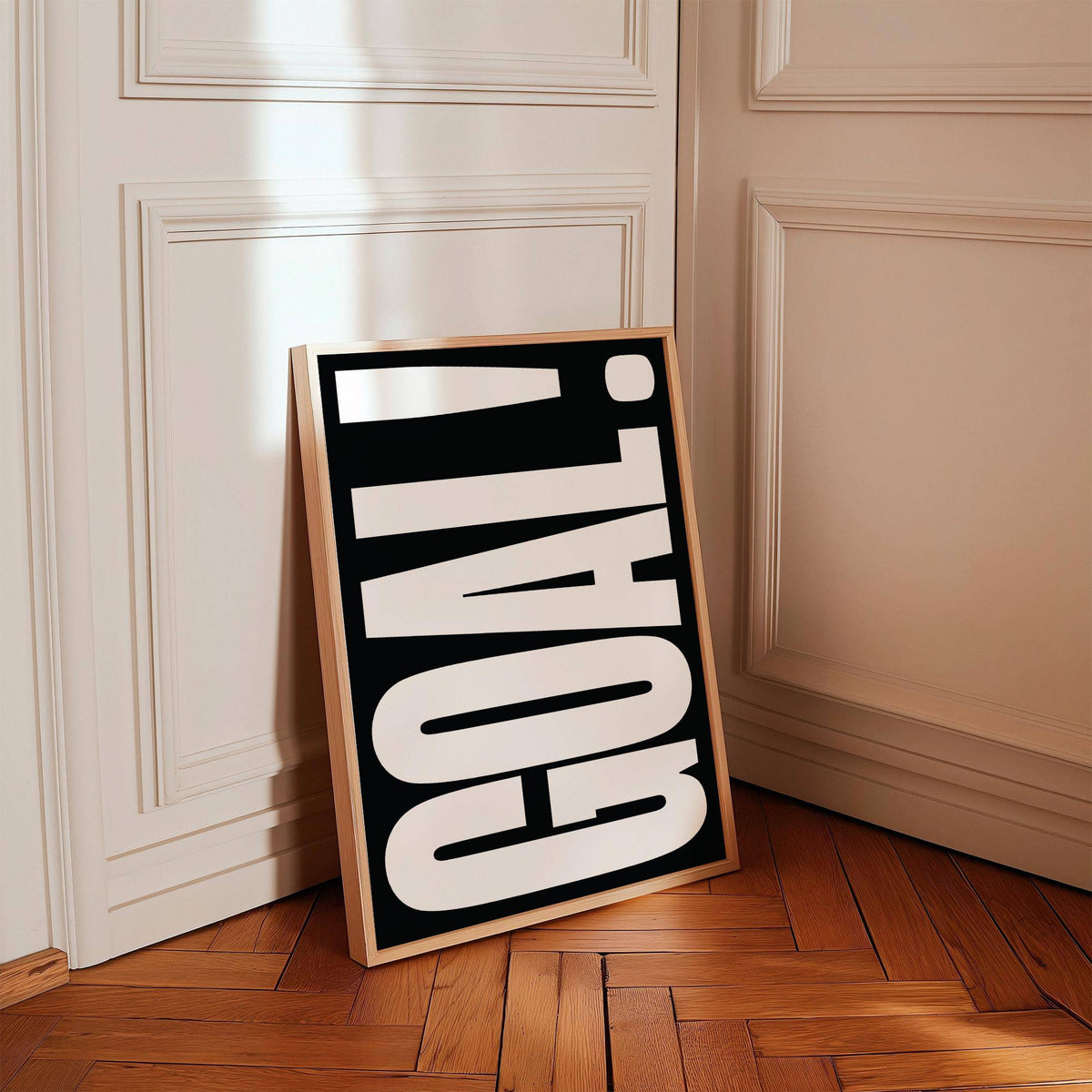 Framed Goal Poster leaning against a beige panelled wall with wooden parquet flooring