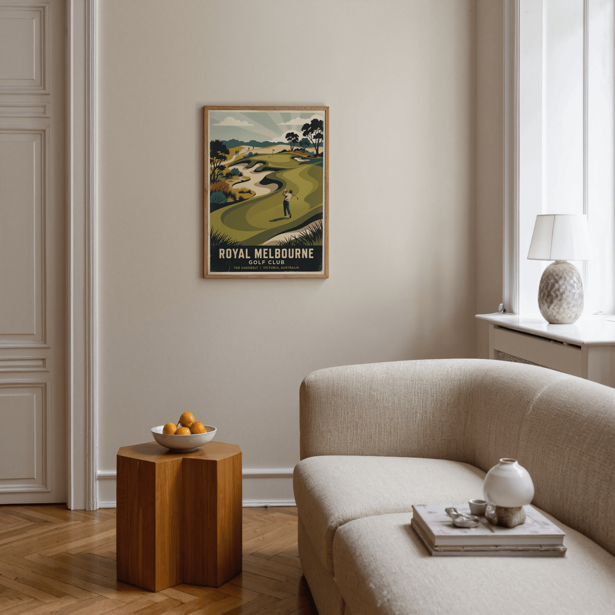 Print of Royal Melbourne Golf Art with retro illustration above a wooden side table in a living room