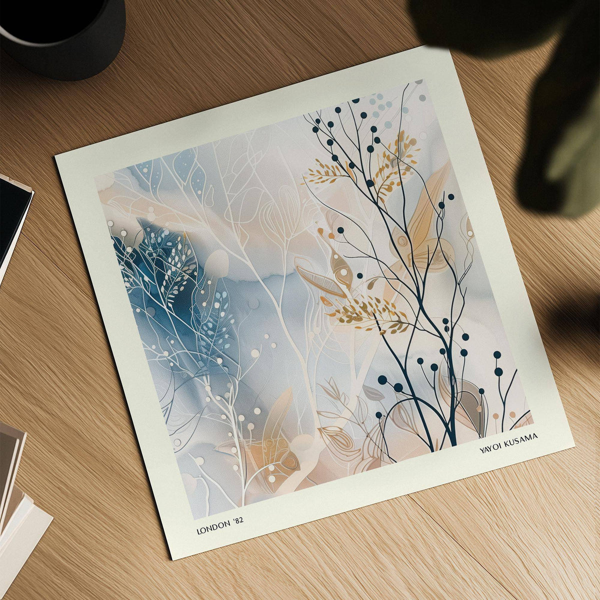 Neutral Prints featuring abstract botanical illustration with blue and beige tones on a wooden surface next to a cup