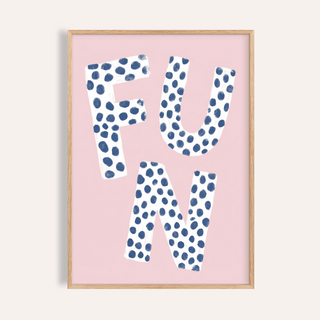 Framed print close-up of fun typography wall art with navy blue polka dots on white letters against a pink background