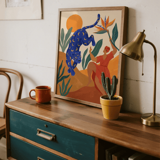Framed Mystical Blue Leopard wall art on a wooden sideboard with a cactus plant and lamp