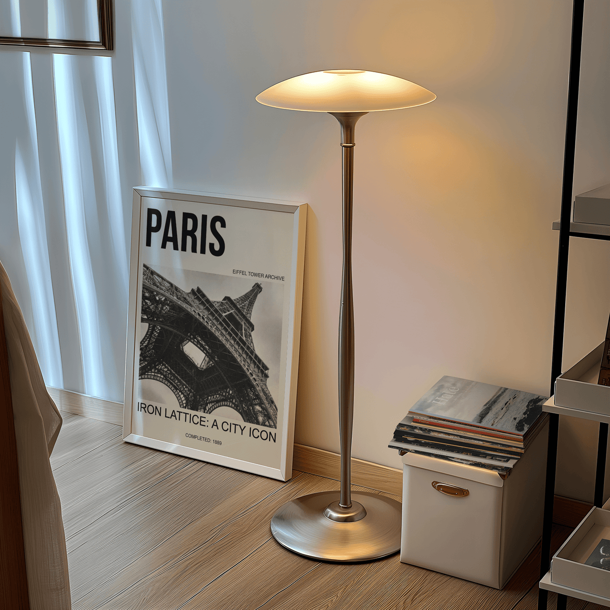 Print leaning on the floor showing Paris Eiffel Tower print in black and white beside a lit floor lamp