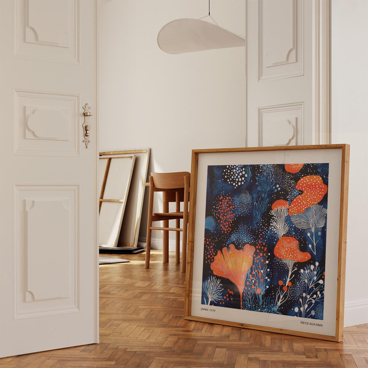 Unique Living Room Wall Art leaning on a wooden floor with a chair behind in a neutral coloured room