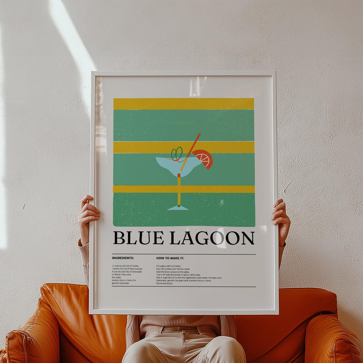 Framed print of Kitchen Wall Pictures showing a minimalist Blue Lagoon cocktail illustration held on a brown leather sofa