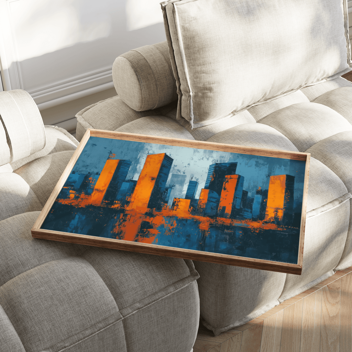 Cityscape wall art tray with abstract blue and orange city skyline on a beige tufted cushion