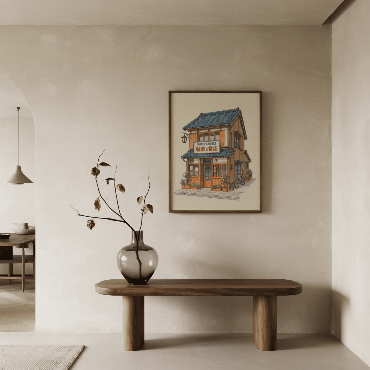Japanese Coffee Poster print of a coffee shop building with blue roof hung above a wooden table with a vase of dried flowers