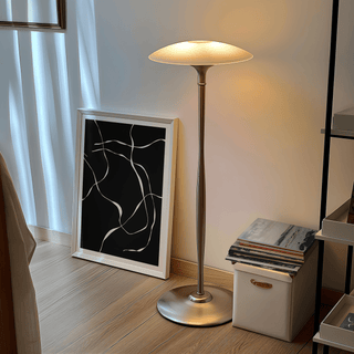 Abstract Lines Art Print leaning on floor beside a silver floor lamp and decorative box