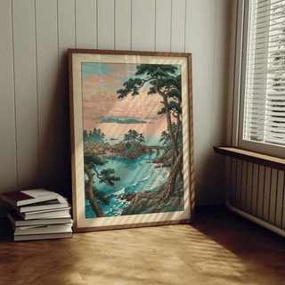 Print leaning on floor showing japanese coastal village with blue sea and trees near window with blinds