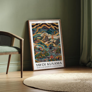 Buddha Poster print leaning against a green wall with a green cushion chair nearby