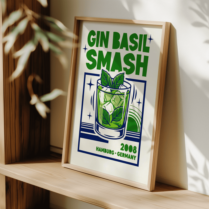 Framed Gin Basil Smash poster leaning on a shelf with green and blue typographic illustration