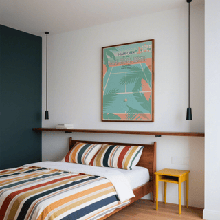 Miami Beach Tennis print on a bedroom wall above a striped bed with a yellow bedside table
