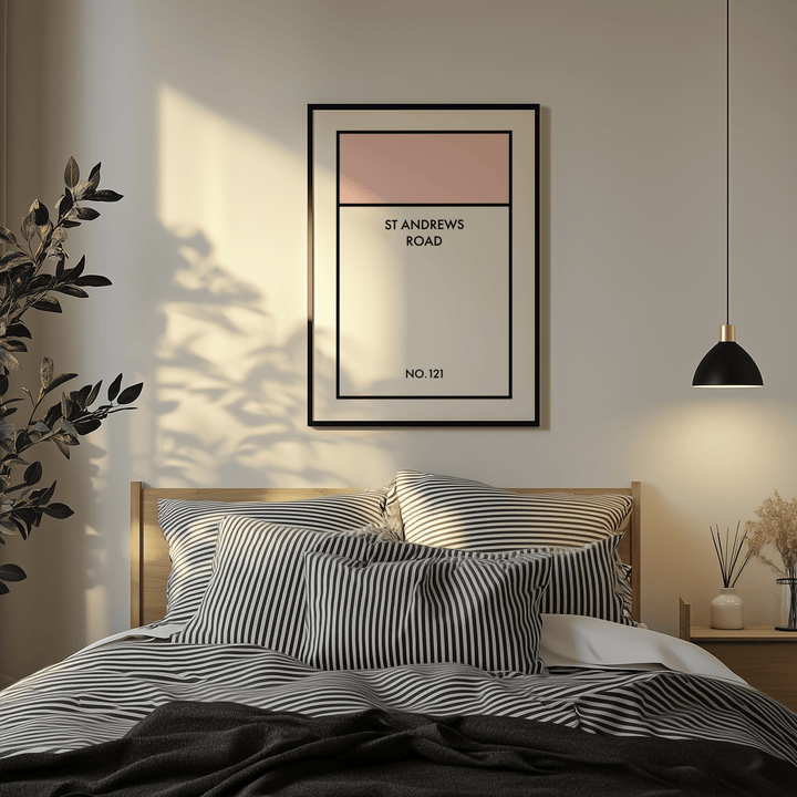 Street Name Family Personal print with soft pink block on wall in bedroom above bed with striped pillows