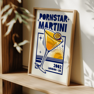 Print leaning on a shelf of a retro passion fruit martini poster with blue and yellow colours and a wooden frame