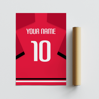 Rolled print with packaging tube of a red football shirt with black sleeve stripe and white number on a grey surface