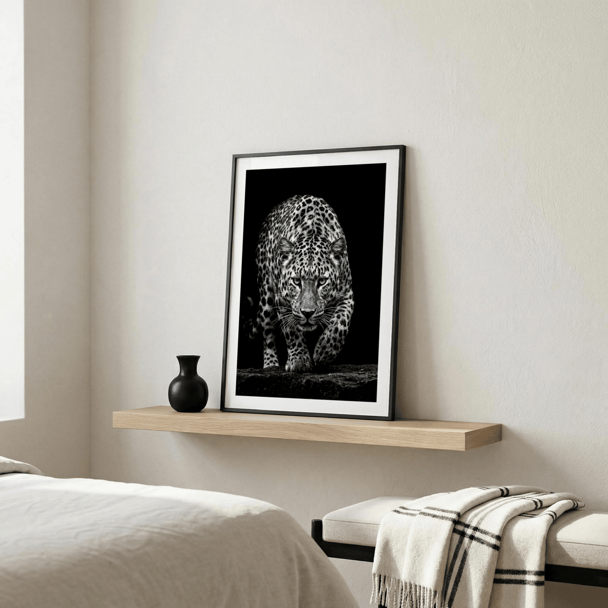 Black Leopard Wall Art leaning on a wooden shelf with a small black vase in a neutral bedroom