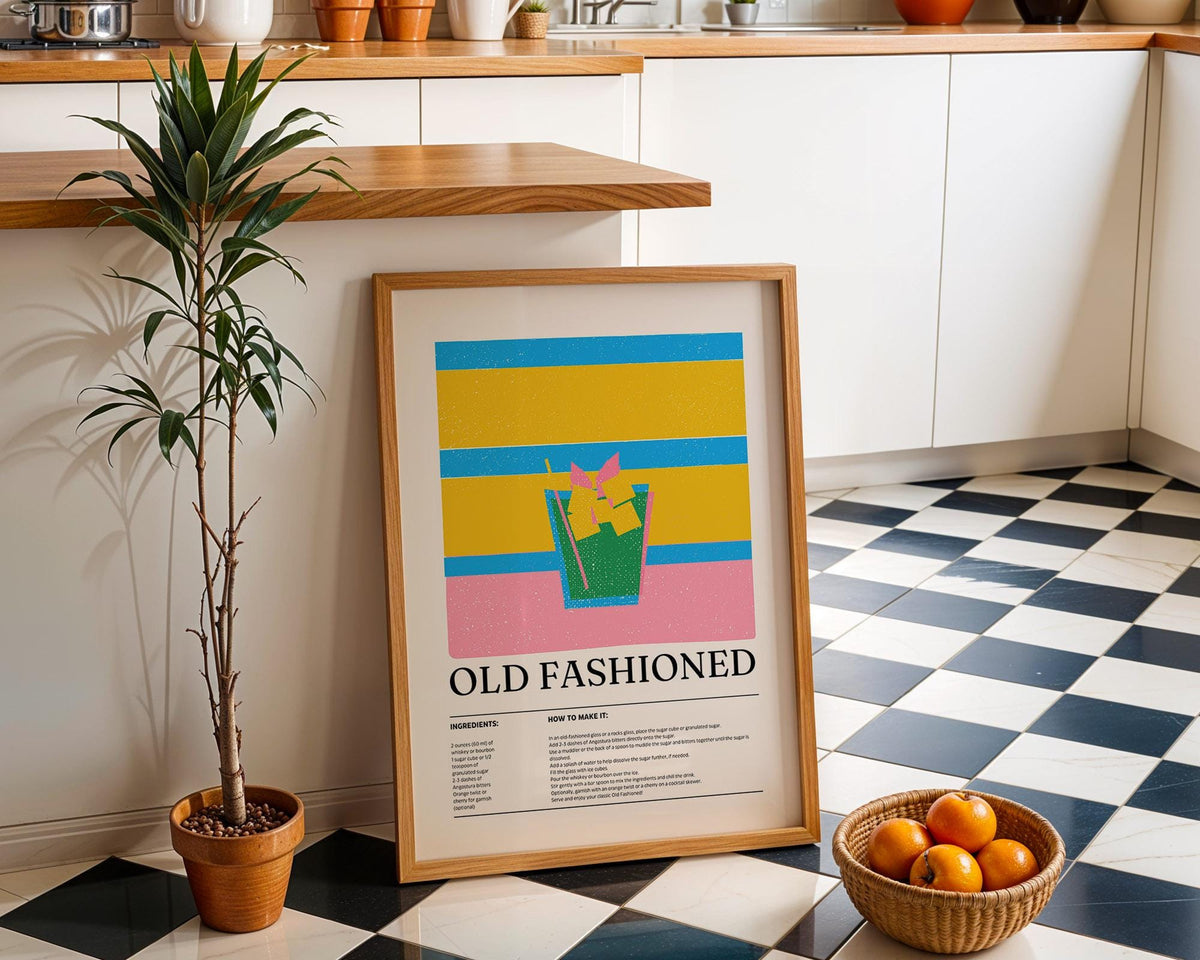 Drink wall art for kitchen leaning on floor next to a potted plant and a basket of oranges