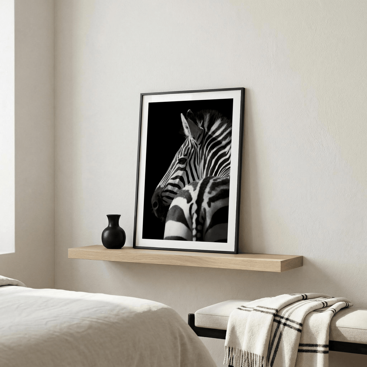 Black And White Zebra Print leaning on a shelf with a small black vase in a neutral bedroom
