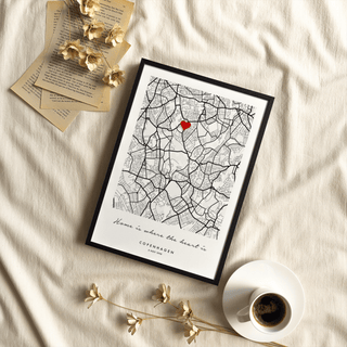 Framed print of Custom Anniversary Gift map with heart detail in black and red on cream fabric background with coffee cup and dried flowers