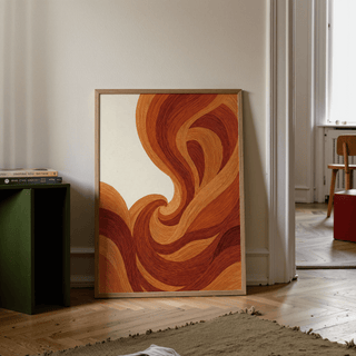 Abstract wave art print leaning on wooden floor with brown and beige wave lines beside a green box holding books