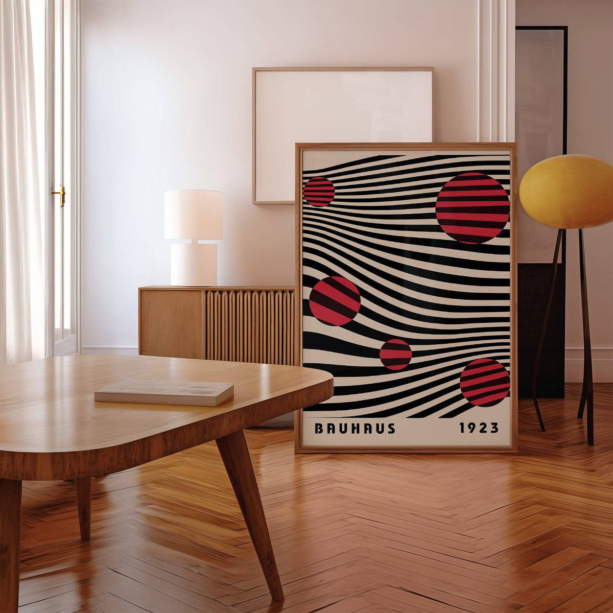 Large Bauhaus wall art leaning on floor with brown frame beside a yellow floor lamp in a room