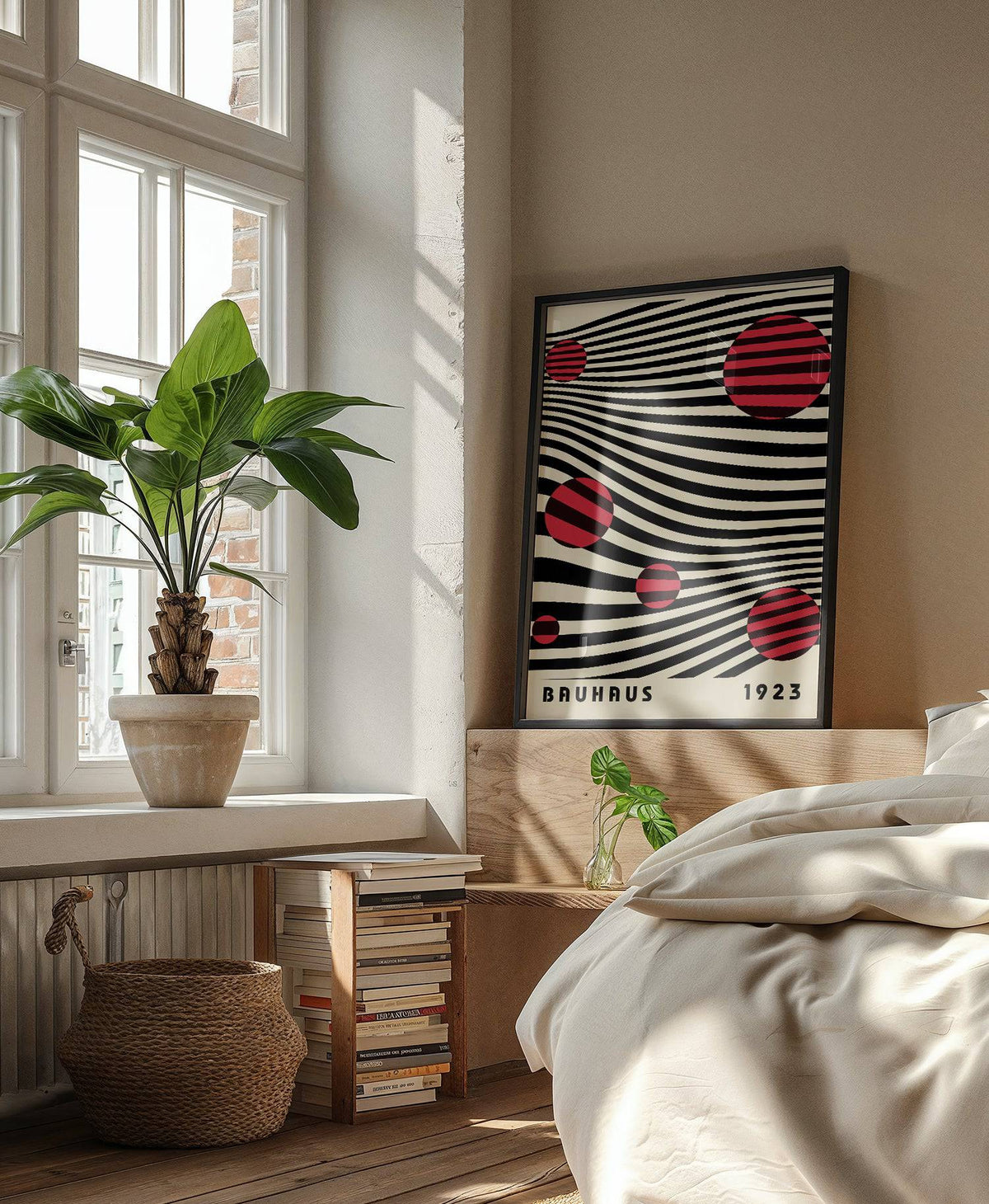 Large Bauhaus wall art leaning on a wooden headboard with a green plant by a window in a bedroom