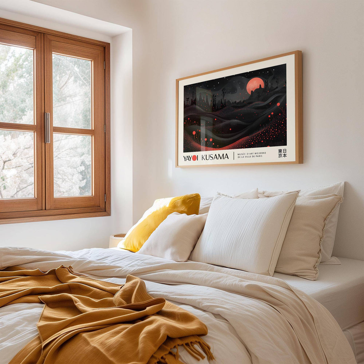Moon Print on a wall in a bedroom with a red moon over surreal dark hills above a white bed with a mustard throw