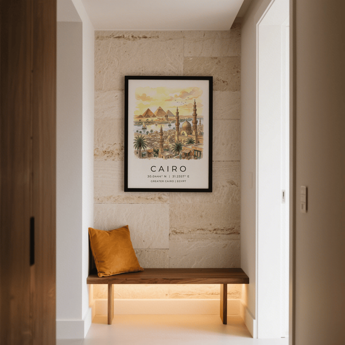 Cairo Landscape wall art of pyramids and city skyline with warm yellow hues above a wooden bench with a brown cushion in a hallway