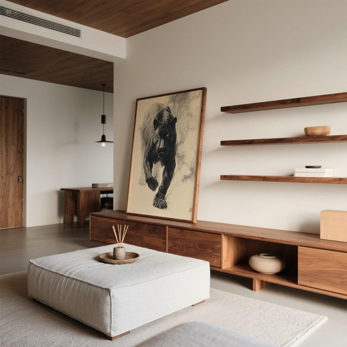 Print leaning on a wooden sideboard of a black panther in motion with grey ink strokes in a minimalist living room