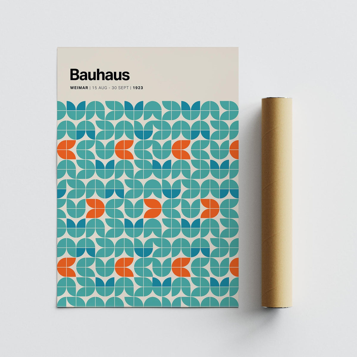 Graphic wall art with modular geometric pattern in blue and orange next to a brown packaging tube