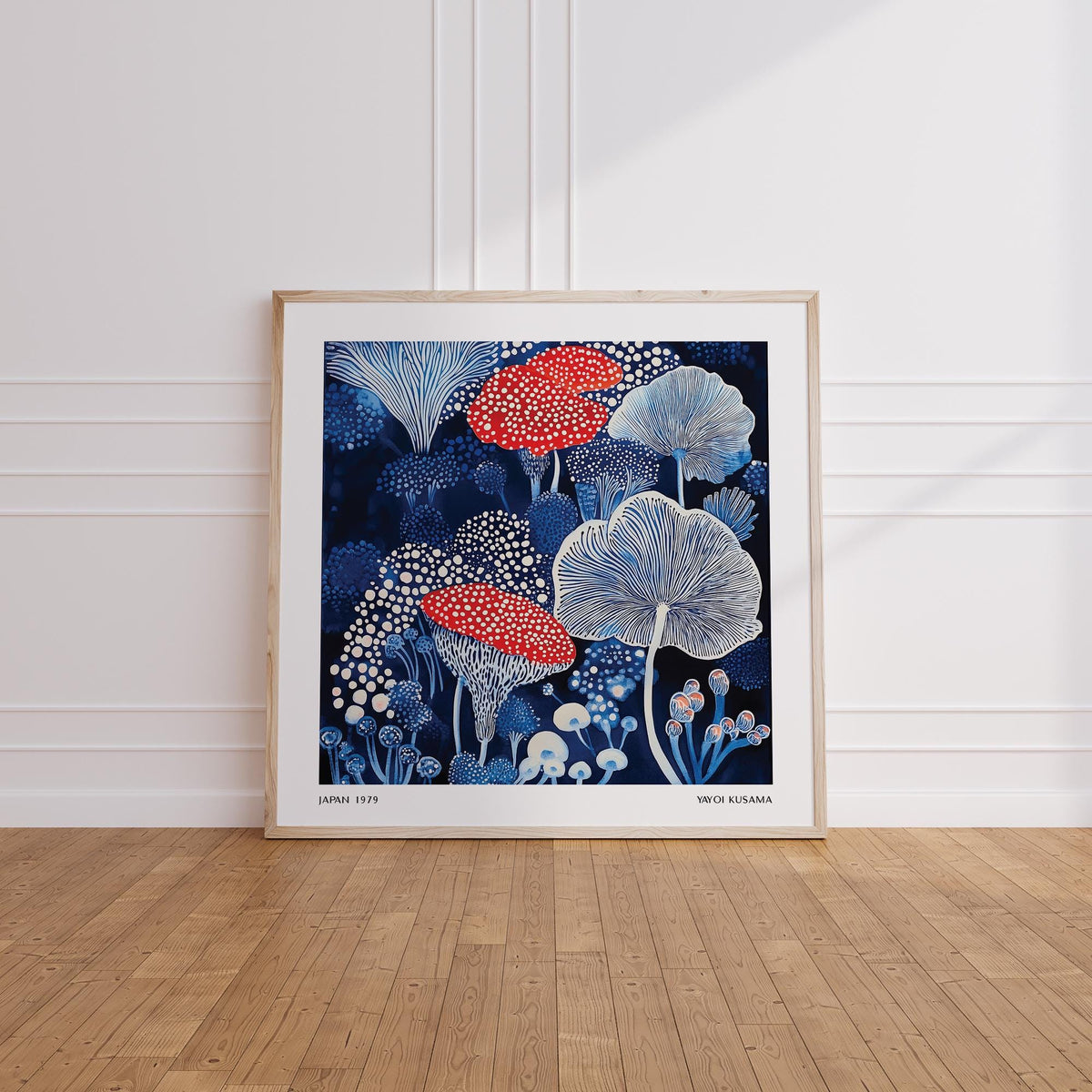 Mushroom poster print leaning on a wooden floor with white wall panels and sunlight