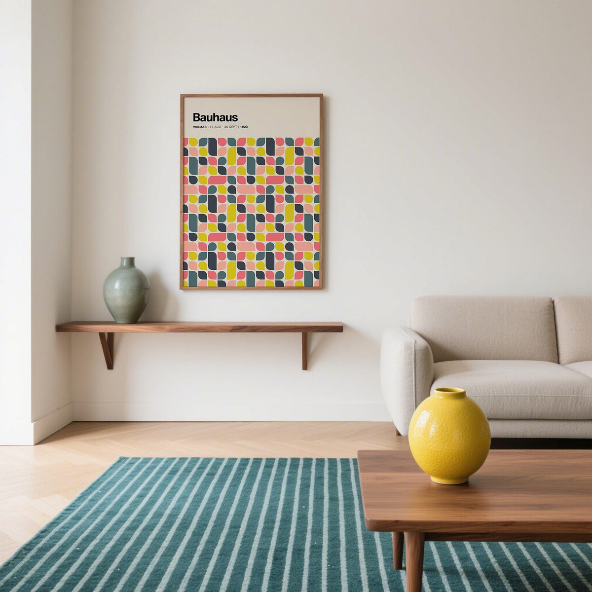 Colorful wall poster with Bauhaus geometric pattern in pink yellow and grey above a wooden shelf in a living room