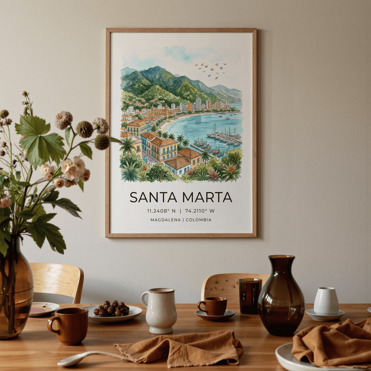 Santa Marta art print of a watercolour coastline and mountains above a dining table with brown and white ceramics