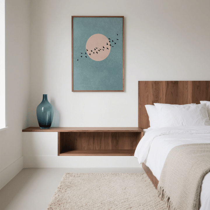 Wall Art Birds print of black birds flying in front of a pink circle on a blue background in a bedroom