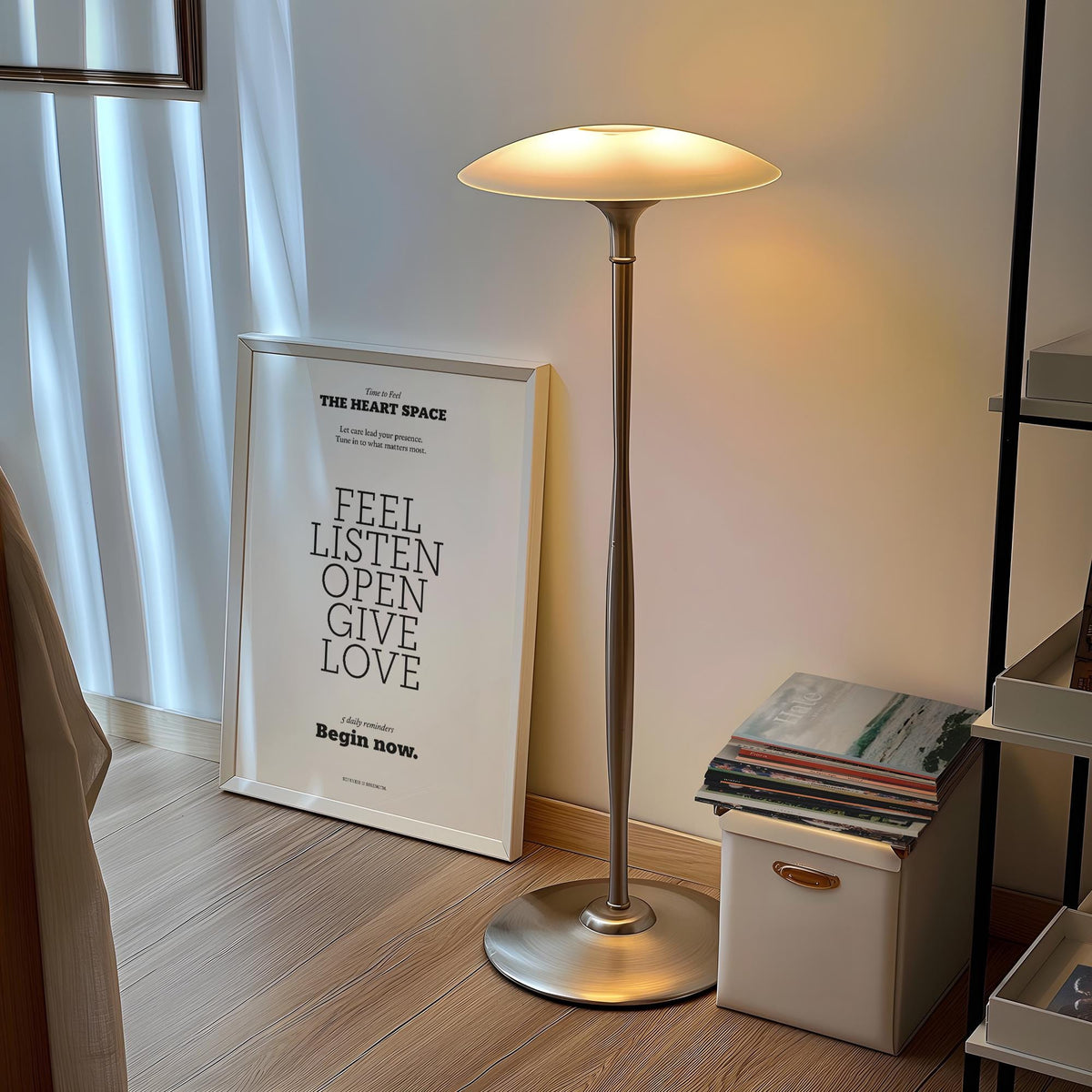 Print leaning with Heart Space motivational quote in black text near a floor lamp and magazines