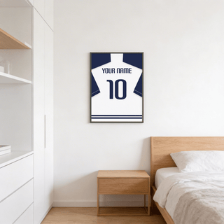 Football Shirt Poster in White with Navy Sleeves and Navy Number on a bedroom wall above a bedside table