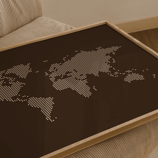 Close-up of world map poster with abstract dot design on a brown background on a corduroy armchair