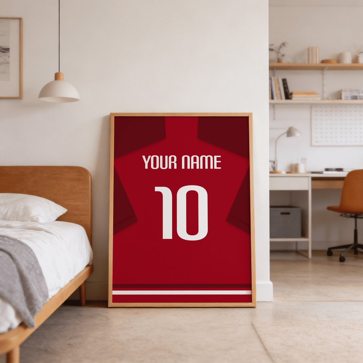 Print leaning on floor of red football shirt poster with dark red sleeves in a bedroom