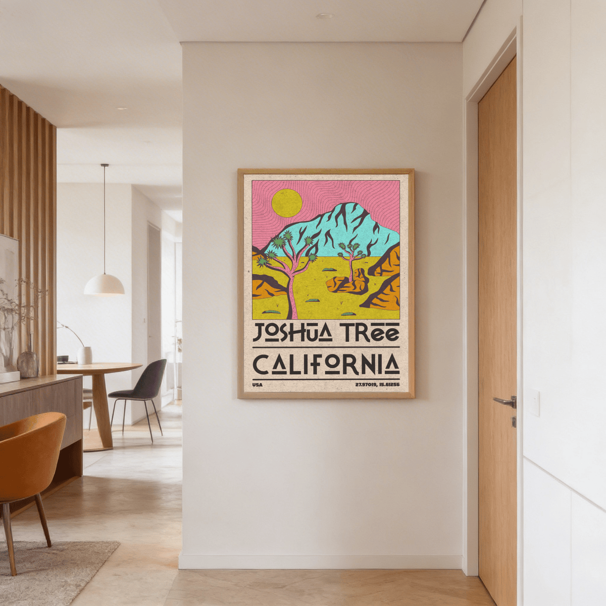 Joshua Tree art print with pink and yellow tones hanging in a hallway near a closed wooden door
