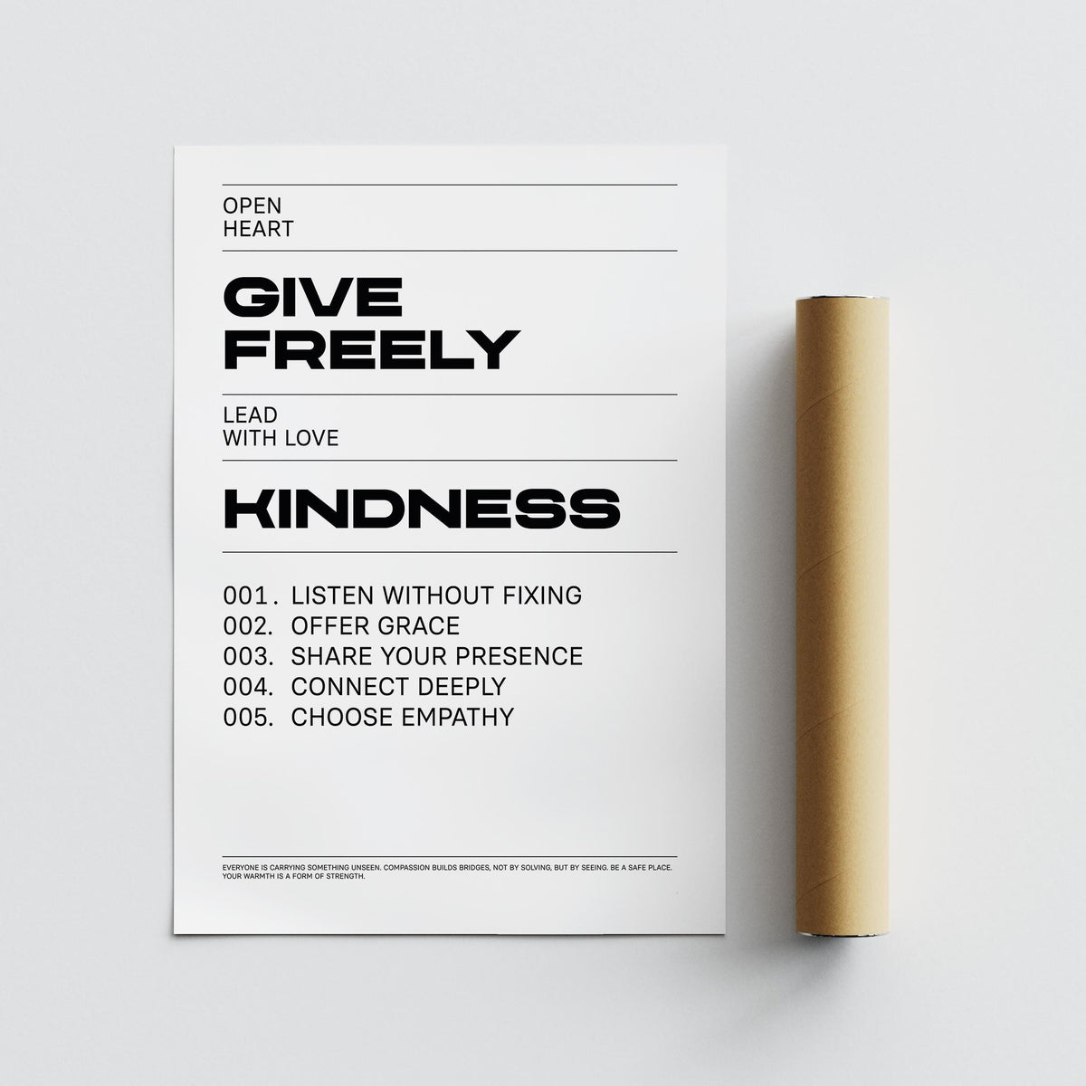 Art with Quotes close-up of a black and white kindness typography print beside a brown packaging tube
