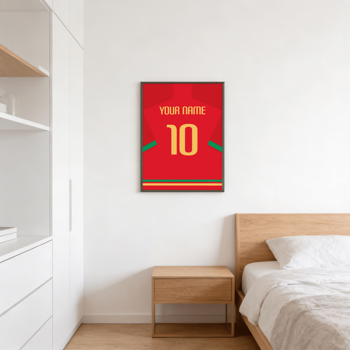 Framed football shirt poster in red with green trim and yellow number hung above bedside table
