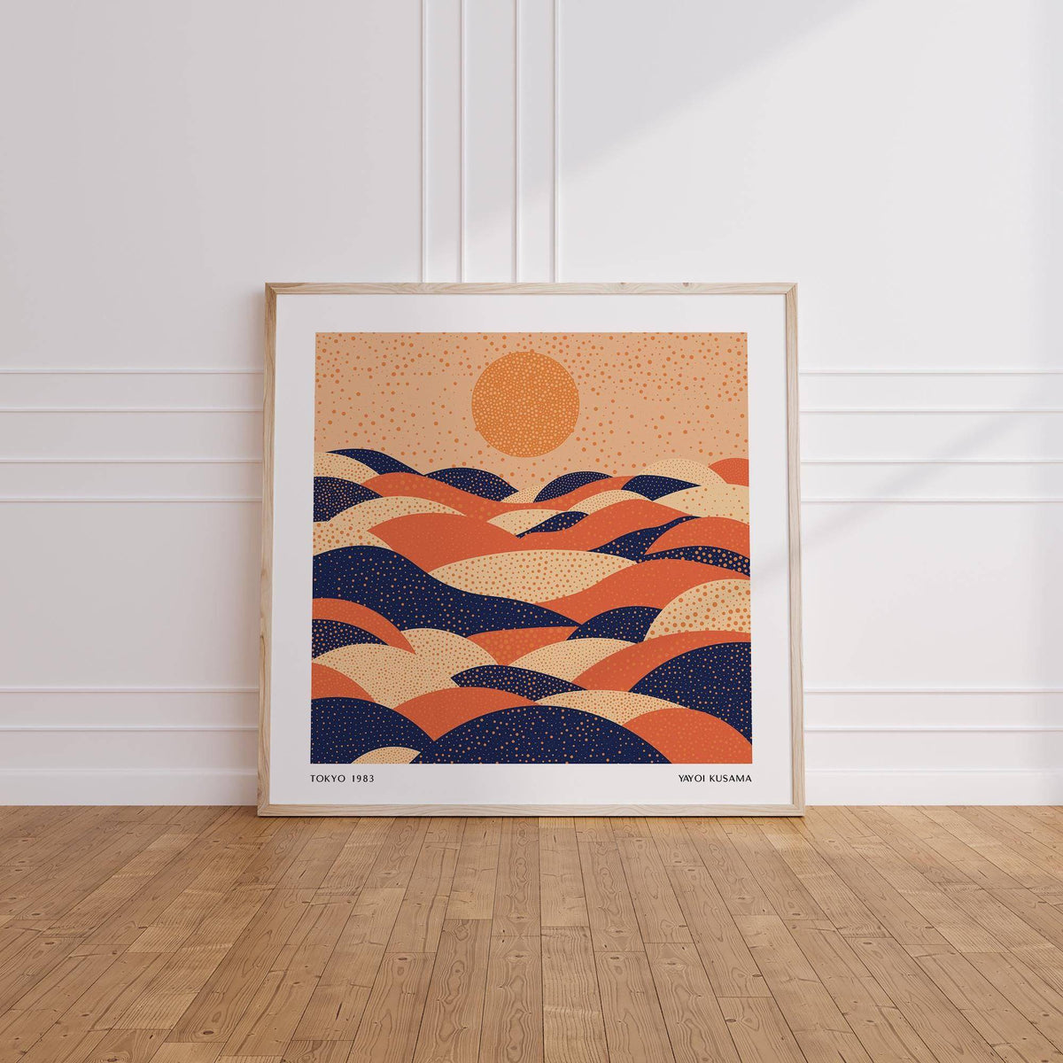 Abstract wall art colourful print of abstract hills and sun leaning on floor against white wall