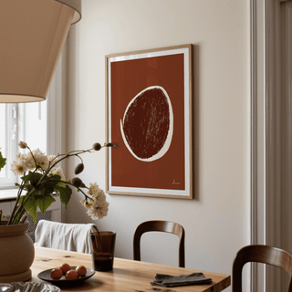 Abstract Earth Tone Art Print with brown and cream shapes hanging in a dining room beside a window and flowers