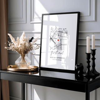 Heart on Map Print leaning on a black surface with dried flowers and black candles nearby