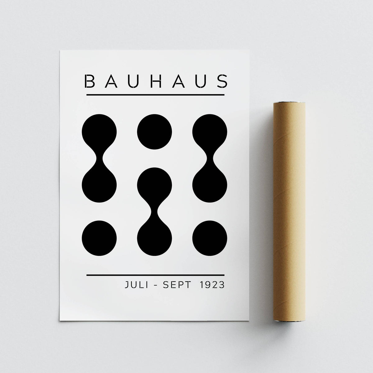 Black White Geometric Art flat print with abstract black shapes beside a brown packaging tube
