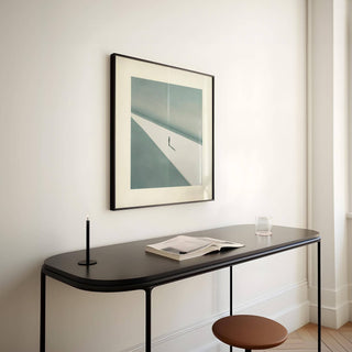Art Prints Square framed print of a solitary person in shadow with beige and blue tones above a black console table