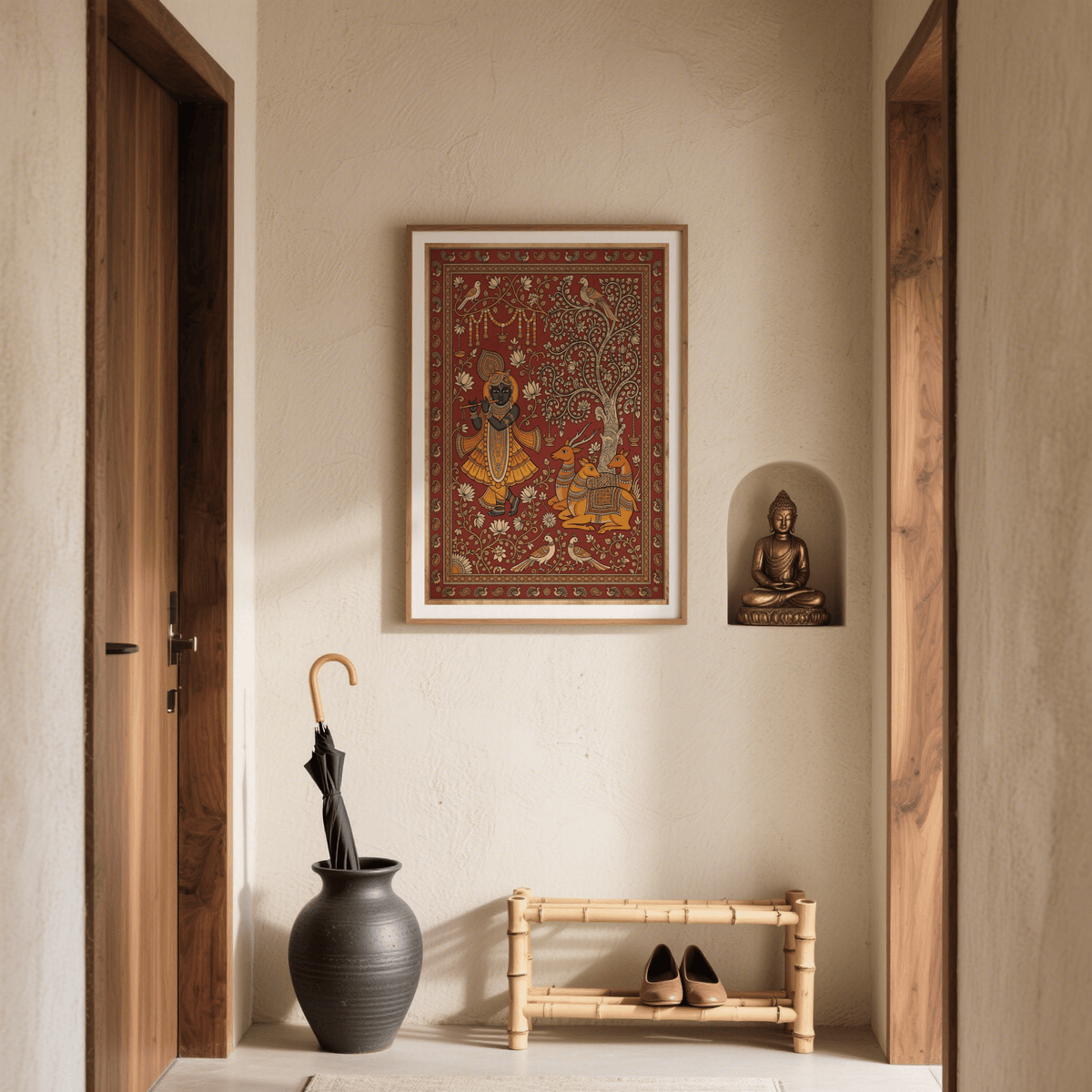 Indian Folk Art Print on a cream wall with a black umbrella in a vase and a Buddha statue in a niche
